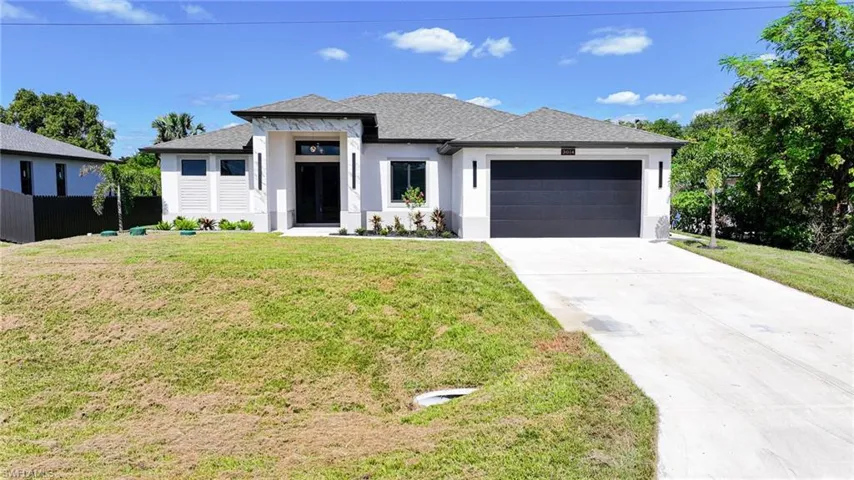 Prairie-style house with roof with shingles, stucco siding, driveway, and an attached garage