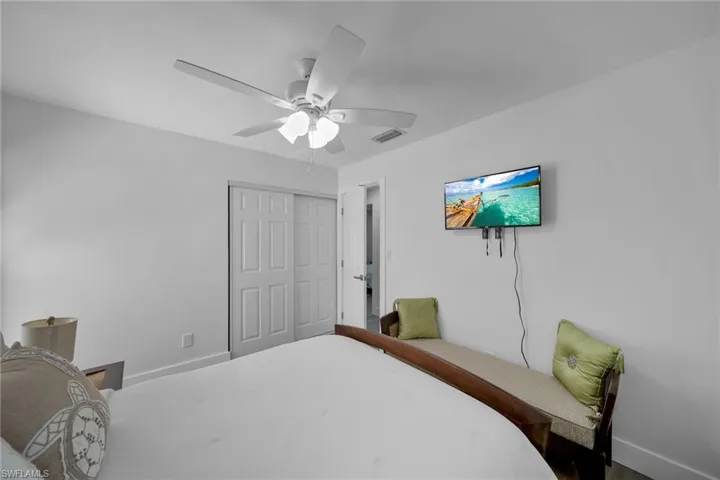 White walls featuring a ceiling fan with integrated lighting