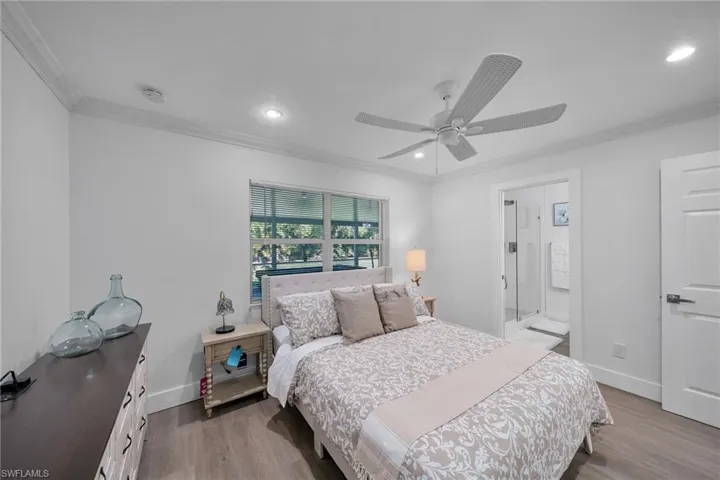 Interior room featuring wood-finish flooring and crown molding