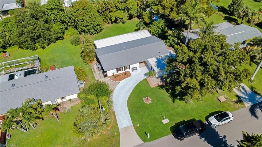 Single-story residence featuring a gray metal roof and a white exterior