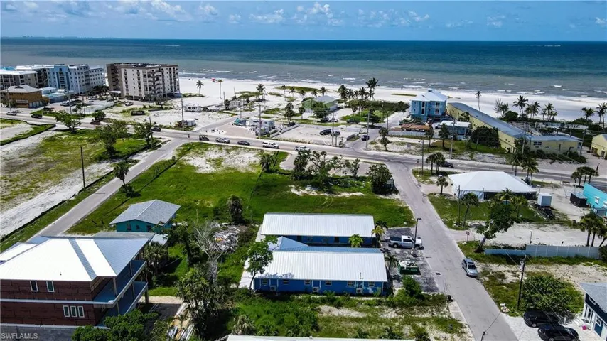 Bird's eye view featuring a water view and a beach view