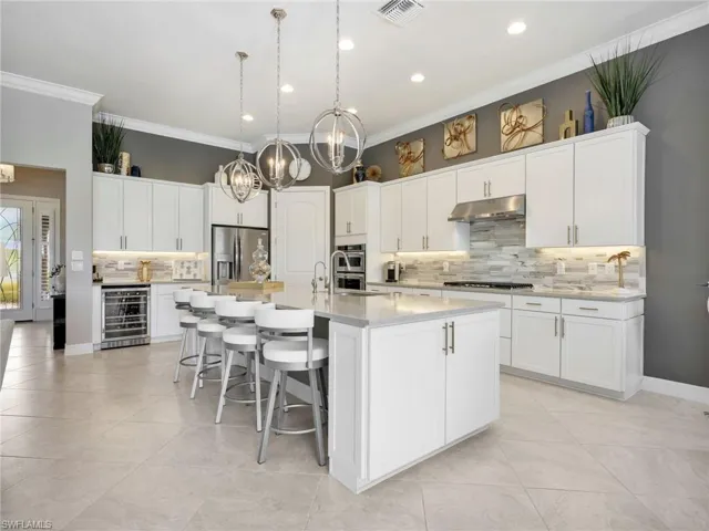 Gourmet Kitchen with Large Island with Seating for 4 with Extra Storage & Stainless Steel Sink & RO Water Filter, Tile Backsplash, Stainless Steel Frigidaire Refrigerator, KitchenAid Gas Cooktop, Hood, & Double Wall Oven, & Dishwasher, & New Air Beverage Fridge