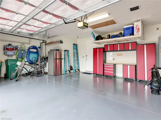 3 Car Garage with Insulated Garage Door, Painted Floor, Garage Storage, & Extra Refrigerator