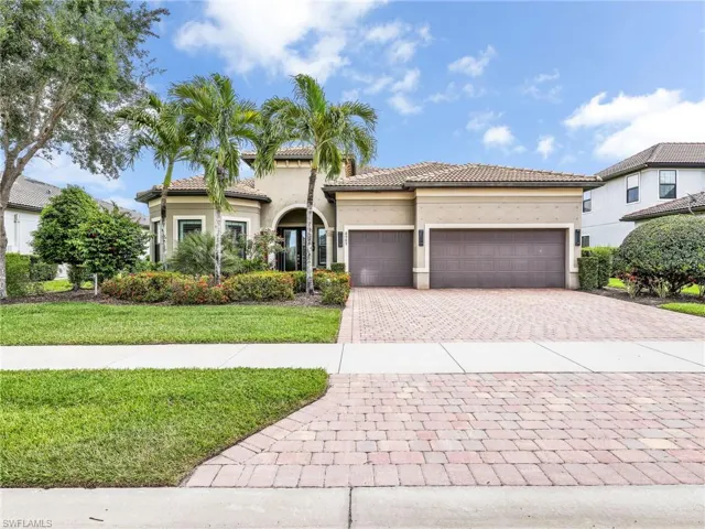 Front of Home Featuring 3 Car Garage and Wide Paver Driveway