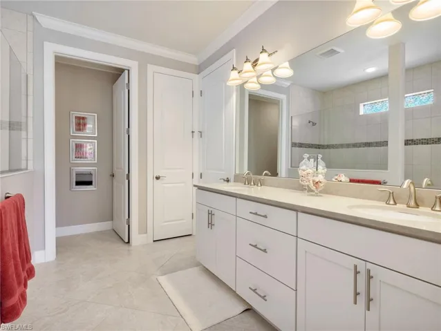 Primary En-Suite Bathroom with Floor To Ceiling Tile Shower with Glass Enclosure & Shower Window for Extra Light, Dual Sinks, Quartz Countertop & Linen Closet