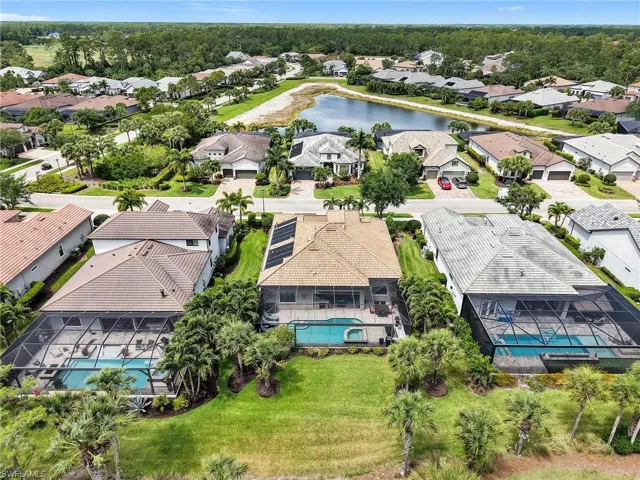 Aerial Rear View of the Home Showing Solar Panels on Roof for Pool Heating