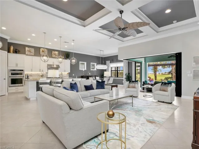Great Room with Zero Corner Sliders to the Lanai, Pool & Spa, and Outdoor Kitchen, Gourmet Kitchen, & Dining Area with Battery Powered Motorized Shade & Custom Curtains