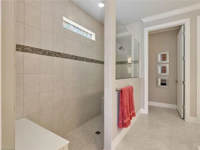 Primary En-Suite Bathroom with Floor to Ceiling Tile, Shower Bench & Glass Enclosure