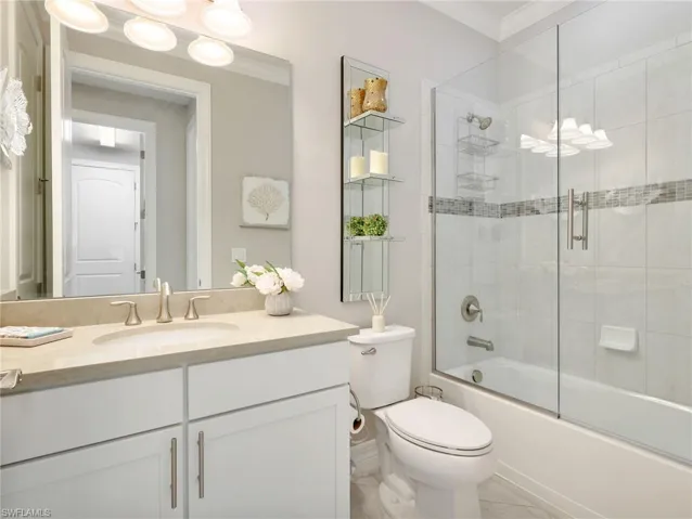 Guest Bathroom with White Shaker Vanity with Quartz Countertop & tiled tub/shower combo with Glass Enclosure