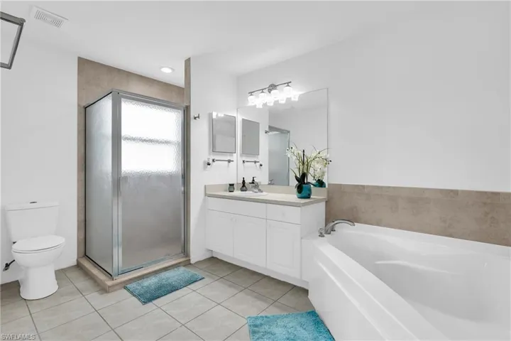 Bathroom featuring visible vents, tile patterned floors, toilet, and vanity