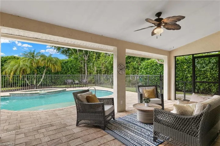View of pool featuring a fenced backyard, an in ground hot tub, a patio area, and a ceiling fan