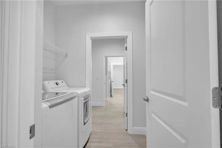 Laundry Room w/ access to the Main Bedroom Closet