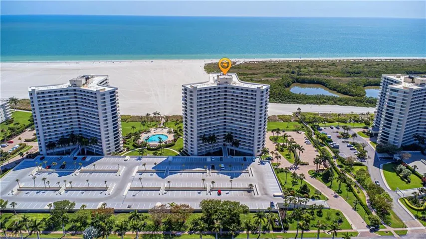 Drone / aerial view with a view of the beach and a water view