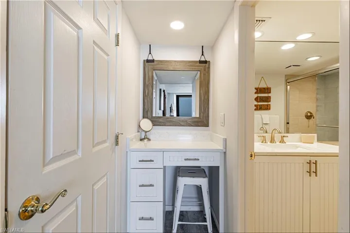 Bathroom featuring vanity and tiled shower
