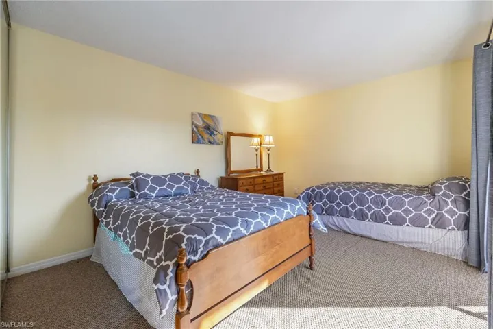 Carpeted bedroom with baseboards