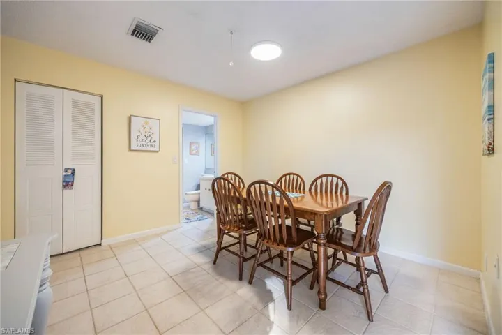 Dining room with light tile patterned flooring and baseboards