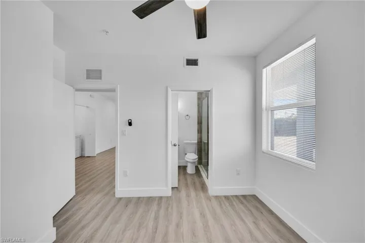 Wood-finish flooring, ceiling fan, white window blinds, and recessed lighting
