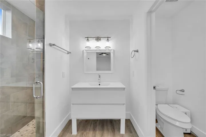 Frameless glass shower enclosure with a tiled interior and built-in bench