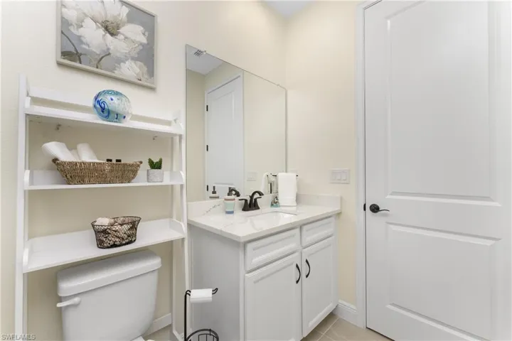Bathroom with vanity, toilet, and tile patterned floors