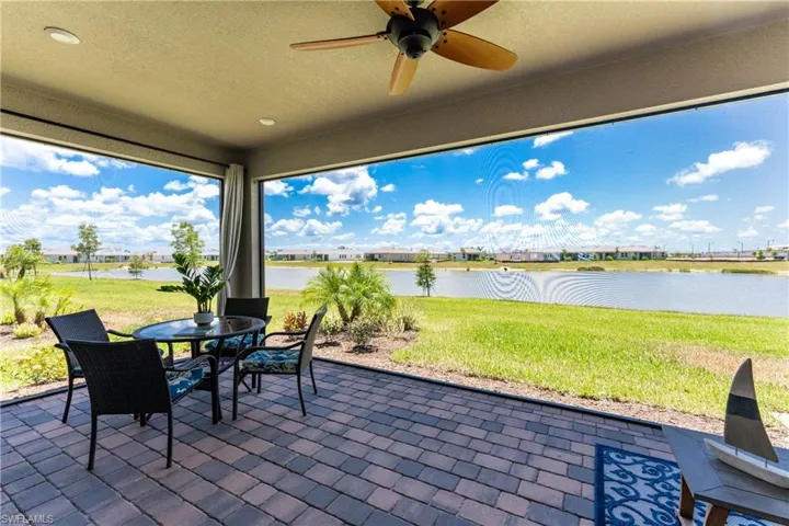 View of patio / terrace with ceiling fan and a water view