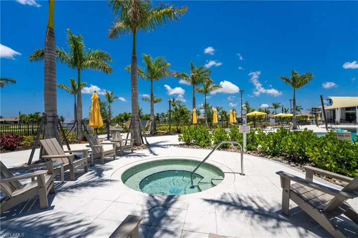 View of swimming pool with a community hot tub and a patio area