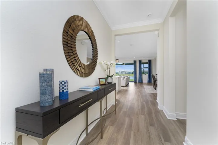 Hall with crown molding and hardwood / wood-style flooring