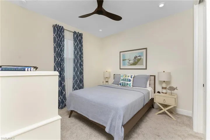 Bedroom with light carpet and ceiling fan