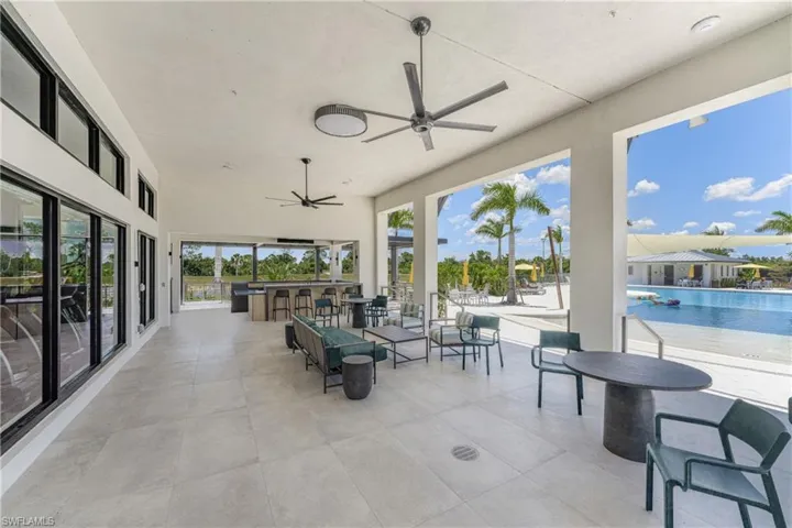 View of patio / terrace with a bar and ceiling fan