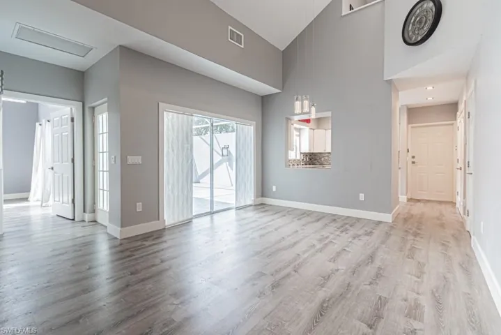 living room with llots of light and vaulted ceiling