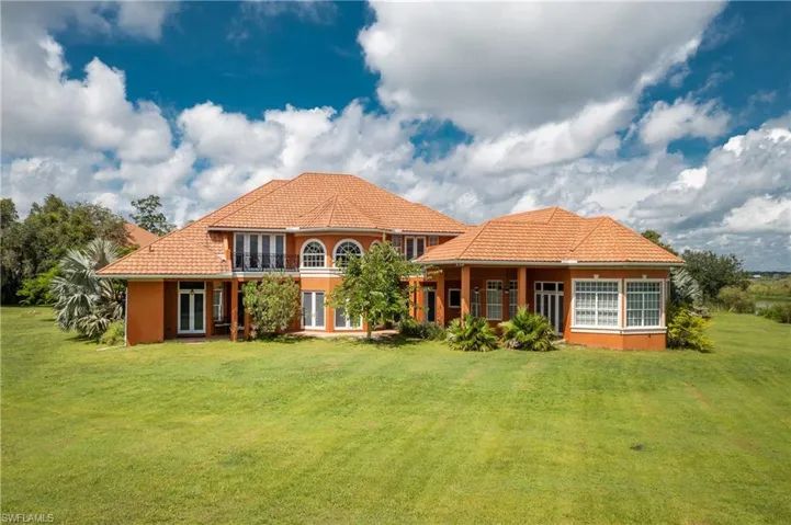 Rear view of house featuring a yard, a metal roof, and french doors