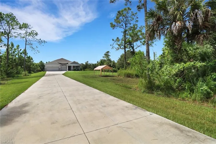 View of front of house with a garage, a gazebo, and a front yard