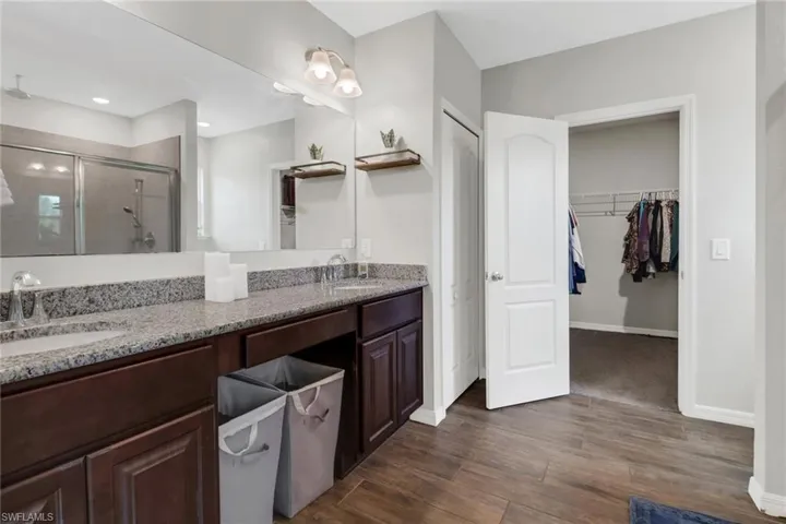 Bathroom featuring an enclosed shower, hardwood / wood-style flooring, and vanity