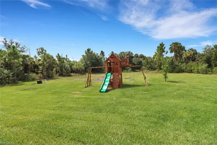 View of playground with a yard