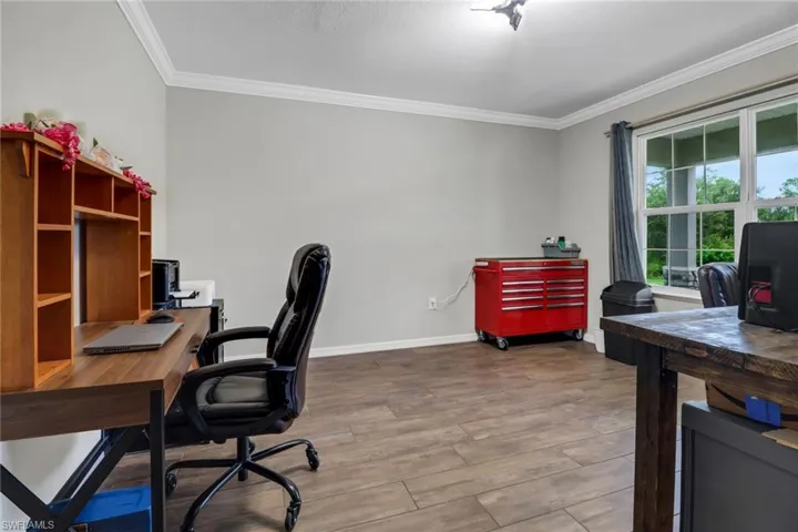 Office featuring hardwood / wood-style floors and crown molding