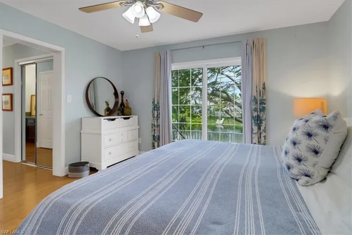 Bedroom with ceiling fan and light hardwood / wood-style flooring