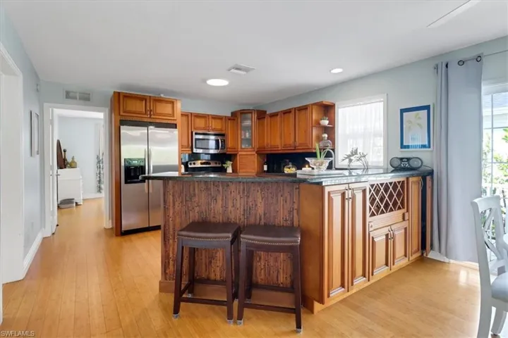 Kitchen featuring stainless steel appliances, granite countertop and remodeled wood cabinets