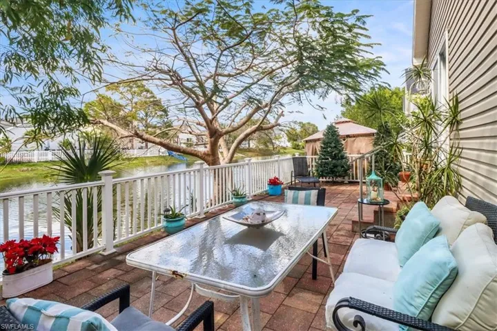 View of patio with a water view and an outdoor living space