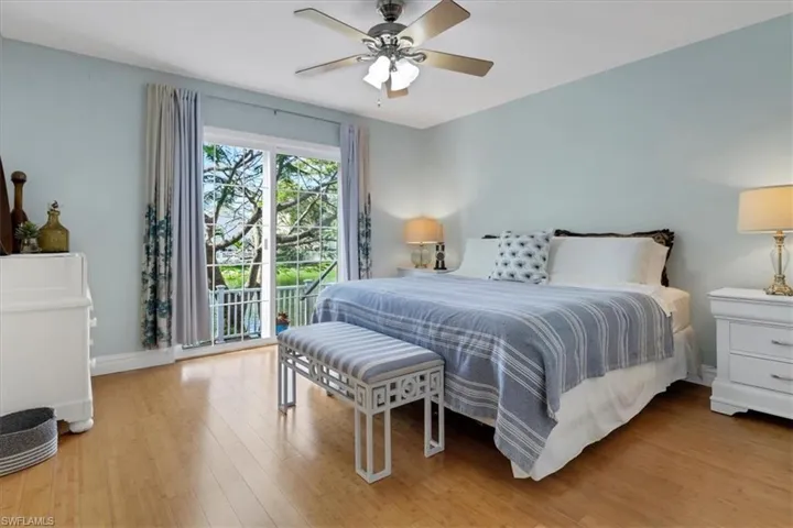 Bedroom with ceiling fan, access to outside, and water view