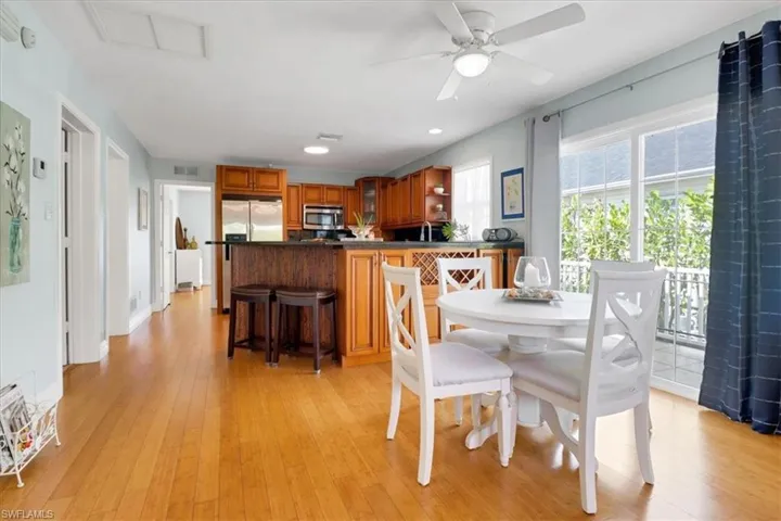 Dining room with ceiling fan, sink, and light hardwood / wood-style floors