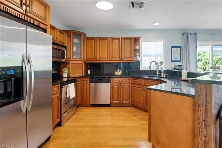 Kitchen featuring granite countertops, wealth of natural light