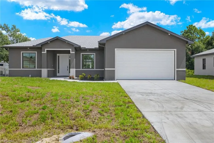 Ranch-style house with a garage and a front yard