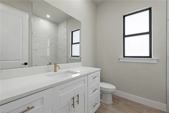 Bathroom featuring tile patterned floors, vanity, and toilet