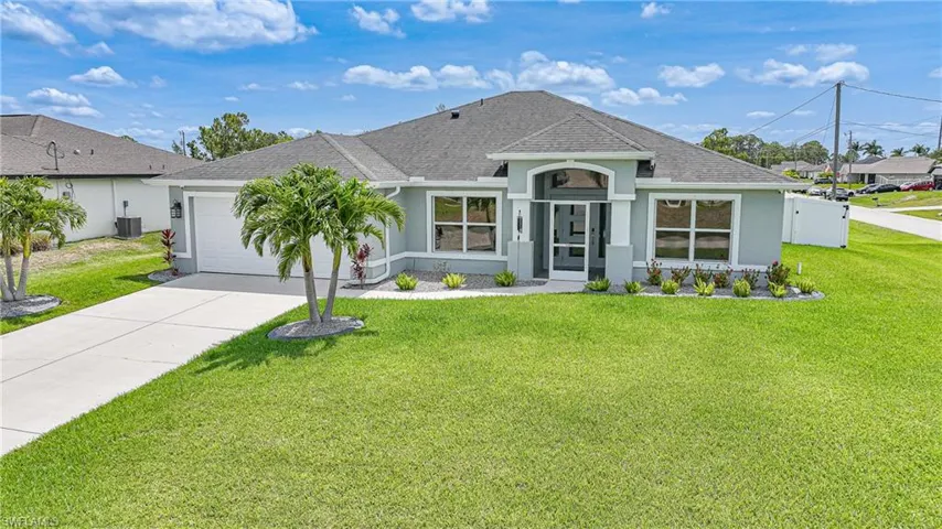 Single story home with stucco siding, a garage, concrete driveway, roof with shingles, and central AC