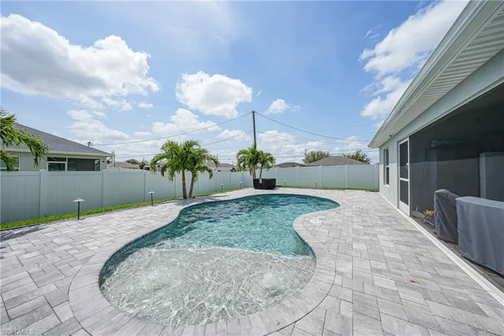 View of swimming pool with a patio area and a fenced backyard