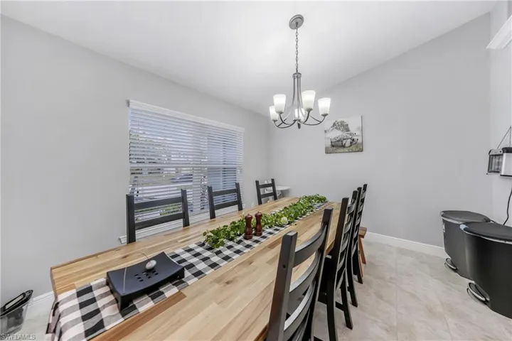 Dining area with a chandelier and baseboards