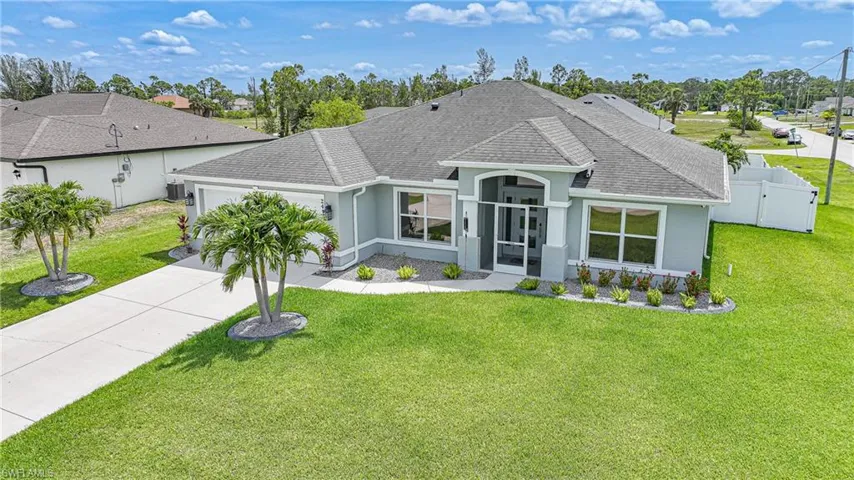 Ranch-style home featuring roof with shingles, an attached garage, stucco siding, and concrete driveway