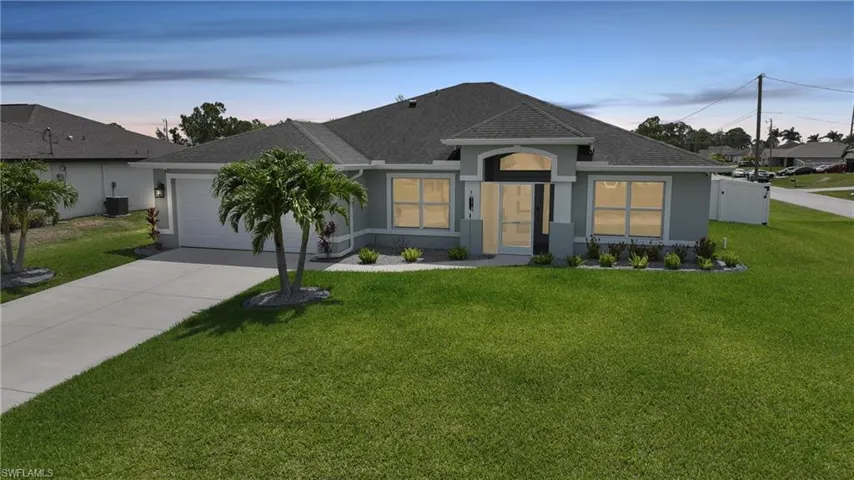 Ranch-style home with roof with shingles, concrete driveway, an attached garage, stucco siding, and central AC unit