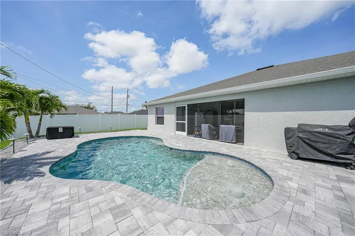 View of pool with a patio and a fenced backyard
