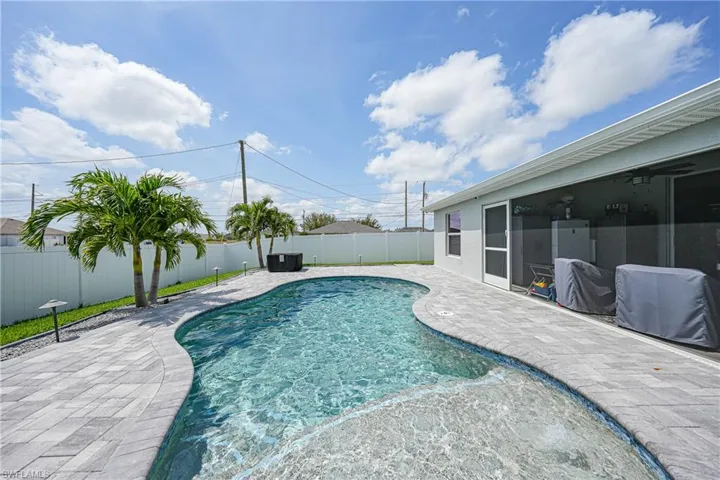 View of swimming pool with a fenced backyard, a patio, and a sunroom