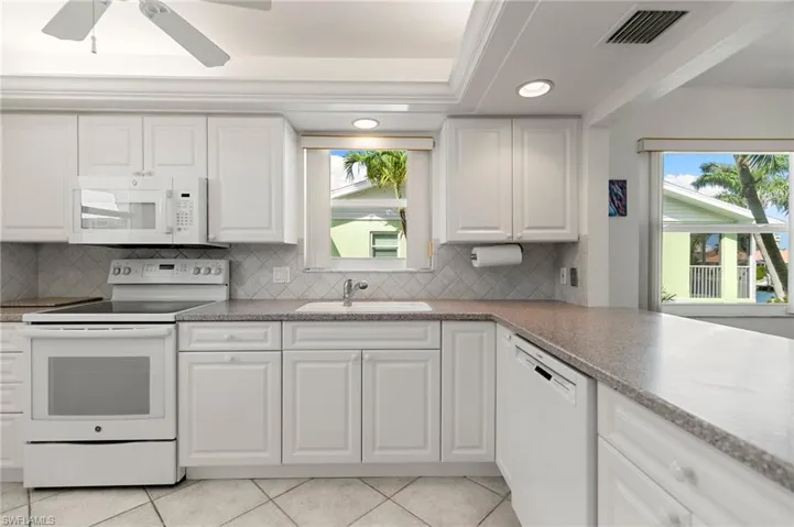 White cabinets and corian countertops